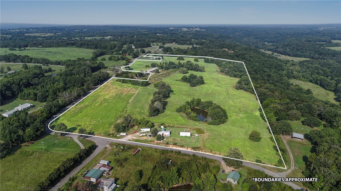 This exceptional 62-acre property features rolling terrain of mature woods and open pastureland.
Strategically positioned on a corner lot. Four scenic ponds and a running creek dot the landscape. The
varied topography and natural beauty make this land ideal for multiple uses - from recreational pursuits
and potential agricultural ventures to subdivision possibilities for residential development. The property
currently features a cozy 1-bedroom main residence with 951 square feet of thoughtfully converted living
space, and an additional 450-square-foot converted utility building added for space. The combination of
premium location, diverse natural features, existing infrastructure, and substantial acreage creates
numerous opportunities for investors, developers, or those seeking a private estate with income
potential. The corner positioning enhances accessibility while the water features and varied terrain add
significant value for any intended use.