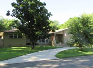 This beautifully remodeled home is oozing Mid-Century Modern charm. Drive by and be awed by the beautifully manicured lawn and landscaping; walk in and be swept away by the details and warmth of this home; step out back and fall in love! It's like your little paradise right in the heart of town. This meticulously remodeled 3 bedroom, 2 bath home is turn key. Enjoy 2 living areas, large eat-in kitchen with center island, gas range and under mount sink. Step out and find a beautiful in ground pool, covered patio, and well disguised storage in the large outbuilding. You'll want to see for yourself!