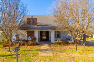 Neat older farmhouse with multiple updates though the years. Large living room, formal dining room, wood fireplace with insert. Solid surface countertop in kitchen. Two bedrooms and bath on main floor. Three bedrooms and bath upstairs. Covered porch, workshop area, 2 metal carports (1 single & 1 double), mature trees, This large farmhouse house deserves your attention! Upstairs is not central heat and air. All #'s approximate. Professional photos coming soon!