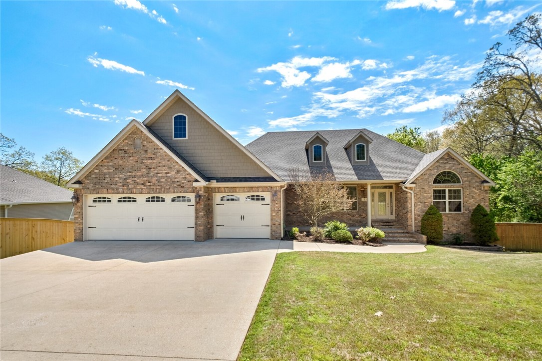 Beautiful home w/ lots of light features a large & open concept for entertaining! A double-sided firplace connects the upstairs LR & family room. Spacious country eat-in kitchen has large island w/ counter seating, a work center, granite countertops, SS appliances & pantry. The Primary bdrm w/ attached bath & walk-in closet has access to covered deck. Also on main floor is 2nd Bdrm & bath making it easy for household members or guests not comfortable w/ stairs. Work at home in the brightly lit office w/ built-in cabinets, bookcases & file drawers. Laundry rm has a sink, double door closet & washer & dryer will stay. Large media room, 2 more bedrooms, a full bath, storage/storm shelter & a workout room are in LL. Outside living space has upper covered & lower deck & patio. 3 car garage w/ stand alone storage cabinets & a refirgerator that will stay. Backyard is fenced & there is an additional dog kennel on side of home. This property is .91A & close to Lake Loch Lomond. The room in this home will amaze you!