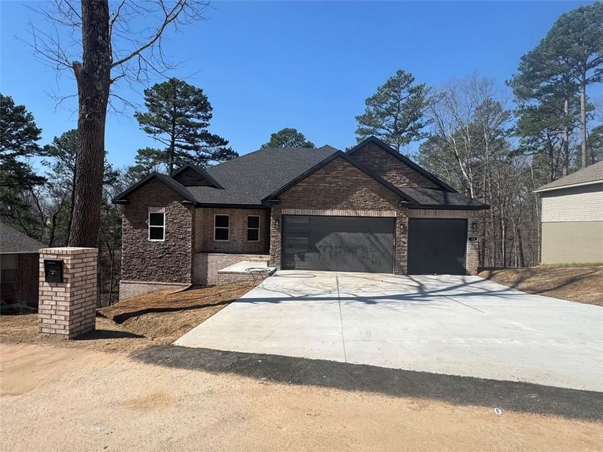 Brand new construction in Bella Vista—just minutes from the Missouri border! This thoughtfully designed 4-bedroom, 2-bath home offers a spacious open floor plan with custom cabinetry, quartz countertops, stainless steel appliances, a cozy fireplace, and large dining and living areas perfect for entertaining. Enjoy the peaceful backyard from your private deck and take advantage of the oversized 3-car garage for vehicles, bikes, and gear. Located near some of the best mountain biking trails, golf courses, and lakes in the region, this home is ideal for outdoor enthusiasts or anyone looking to enjoy the Bella Vista lifestyle. Modern finishes, a great location, and natural beauty combine to make this a must-see home. Schedule your showing today and experience all this amazing property has to offer. Agent-owned/builder/partial investor.