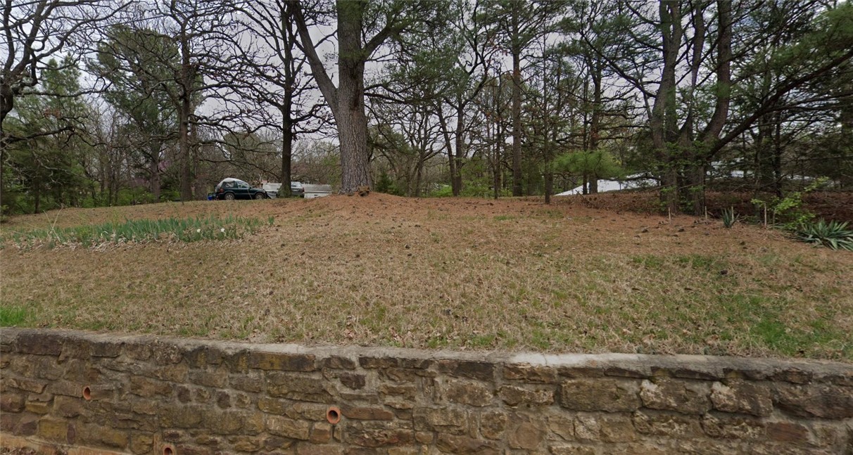 Prime .73-acre lot in a central Fayetteville location! Property includes a house considered a tear-down, offering the perfect canvas for redevelopment. Currently zoned residential, but sellers have met with the City and rezoning to multi-family may be considered with proper due diligence. This property provides a variety of possibilities in a highly desirable area near the University of Arkansas, Wilson Park, bus routes, and with easy access to I-49. Buyer is responsible for verifying zoning and development options.