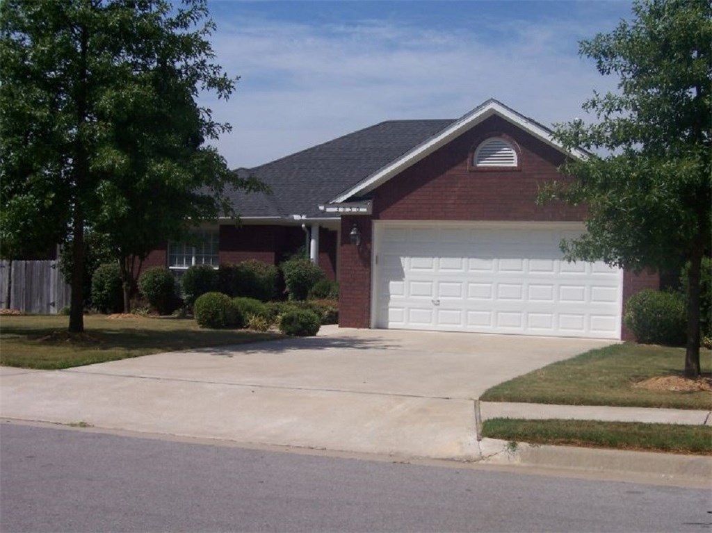 All brick home with open floor plan. New vinyl wood look flooring in the living room and carpet on the bedrooms. Large living room has corner fireplace with gas logs and is open to dining space with 3 windows making a bay. Adjoining kitchen has lots of storage cabinets and second dining / bonus area. Large walk-in pantry closet plus big utility room. Master bedroom has 2 double closets, and bathroom has full tub/shower and double-sink vanity. Crown molding, blinds and ceiling fans throughout. Covered front porch, large wood back deck, fenced yard and double enclosed garage. Conveniently located near I-49, offices, medical facilities, shopping & entertainment.