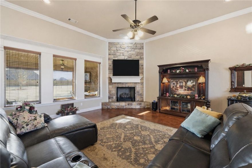 Experience the best of Farmington in the sought-after Twin Falls subdivision. This stunning, one owner, custom home on a large corner lot offers the perfect blend of luxury and comfort. Step through the beautiful wood doors into an open-concept interior that impresses with soaring ceilings, a cozy rock fireplace, and abundant natural light. A spacious kitchen serves as the heart of the home and perfect for entertaining. Granite counters, custom cabinetry, a large island, gas cooktop, double ovens, and a walk-in pantry finish out this amazing space. The split floorplan offers a private large primary suite and 3 bedrooms on the opposite side of the home. Step outside to your personal backyard retreat to experience beautiful sunsets in your screened-in covered patio with adjustable sun shades, gas fireplace, and TV providing an exceptional setting for relaxing in privacy. 3-car garage has plenty of room for projects, hobbies, or a home gym. Whole house vacuum makes cleaning a breeze! New gas water heater APR 2026.