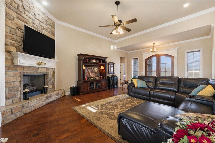 Experience the best of Farmington in the sought-after Twin Falls subdivision. This stunning, one owner, custom home on a large corner lot offers the perfect blend of luxury and comfort. Step through the beautiful wood doors into an open-concept interior that impresses with soaring ceilings, a cozy rock fireplace, and abundant natural light. A spacious kitchen serves as the heart of the home and perfect for entertaining. Granite counters, custom cabinetry, a large island, gas cooktop, double ovens, and a walk-in pantry finish out this amazing space. The split floorplan offers a private large primary suite and 3 bedrooms on the opposite side of the home. Step outside to your personal backyard retreat to experience beautiful sunsets in your screened-in covered patio with adjustable sun shades, gas fireplace, and TV providing an exceptional setting for relaxing in privacy. 3-car garage has plenty of room for projects, hobbies, or a home gym. Whole house vacuum makes cleaning a breeze! New gas water heater APR 2026.