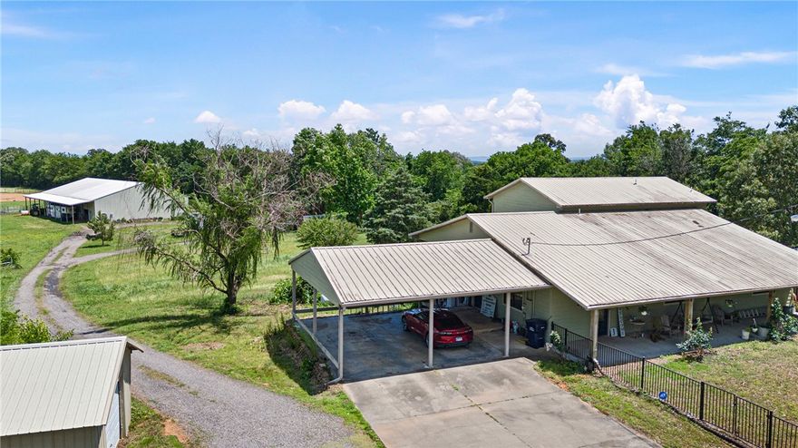 Embrace country living on 14.71± acres near scenic Mt. Nebo! This 3-bed, 4-bath home features 12-ft ceilings, 2 living areas, gas fireplaces, and a sunroom / office. Two bedrooms have private baths and deck access with stunning views. The kitchen boasts a gas cooktop, walk-in pantry, and ample space. Enjoy the stocked pond from the expansive deck. A 24x30 shop with 30-amp hookup, and extra outbuilding offer great storage. Horse lovers will appreciate the 7 stalls, wash rack, tack and feed rooms, plus covered RV parking (30 amp & dump station). Ride year-round under the 40x60 awning or train in the outdoor riding area. Fenced pasture includes loafing shed. The barn has a full bath, and there's a circle drive for easy access. Security system with 3 cameras adds peace of mind. Don't miss this unique blend of comfort and function—schedule your showing today!