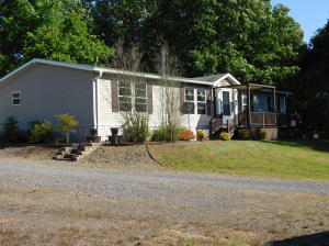 This home can be purchased with FHA or VA loans. The home has an open floor plan with large bedrooms, a fireplace in the living room, and a large beautiful kitchen with a stylish island. This spacious yard features a park-like atmosphere with large trees and branch swings, a picnic table, and well kept grounds. The wooden deck includes a fire pit. There is a wheelchair ramp for entry in the back door. There is also a storm shelter. The property feels secluded although it is right outside the city limits.