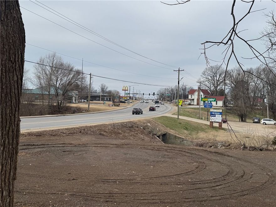 Large commercial tract in Farmington with appx 300 ft of Hwy 62 frontage in 2 parcels. Zoned commercial. Lots of options, very close to McDonald's, Sonic, Dollar Tree & First Security Bank. 36,000 traffic count