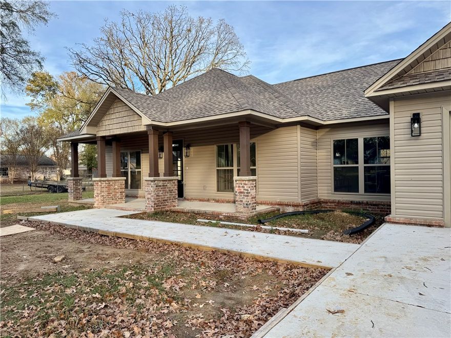 Welcome to this beautifully crafted 3-bedroom, 2-bath home that blends timeless curb appeal with modern comfort. Inside, you’ll find an inviting layout with three spacious bedrooms plus a dedicated office, perfect for working from home or creating a quiet reading retreat. Natural light fills the living spaces, and the thoughtful floor plan offers both function and flow. The kitchen, dining, and living areas transition seamlessly to the outdoors, where a covered concrete back porch expands your living space and offers the ideal spot for morning coffee, weekend grilling, or evenings spent unwinding. Located in a peaceful neighborhood with mature trees and generous yard space, this home offers the comfort of new construction with the charm of a well-established setting.