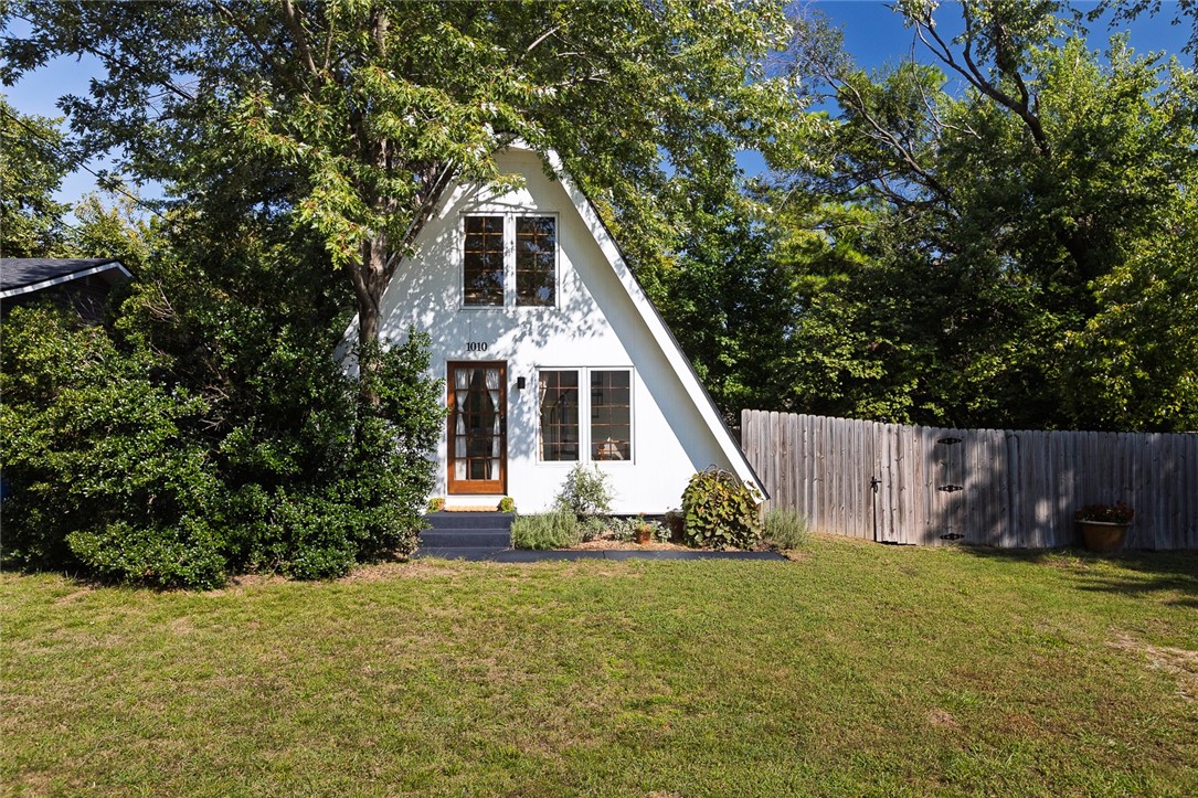 This charming A-frame is ideally located between Coler Mountain Bike Preserve and downtown Bentonville, offering the perfect blend of convenience and character. Set on a quiet street with a private backyard, fenced yard, and mature trees, the home provides a peaceful setting just minutes from trails, restaurants, and shopping. Inside, you’ll find hardwood and slate tile floors, a Viking gas range, and refrigerator drawers—all combining function with style. With its distinctive design, this property is a great fit for someone looking for a unique home in town, or for buyers seeking an already income-producing Airbnb. It’s a rare opportunity to own a distinctive space in one of Bentonville’s most sought-after locations.