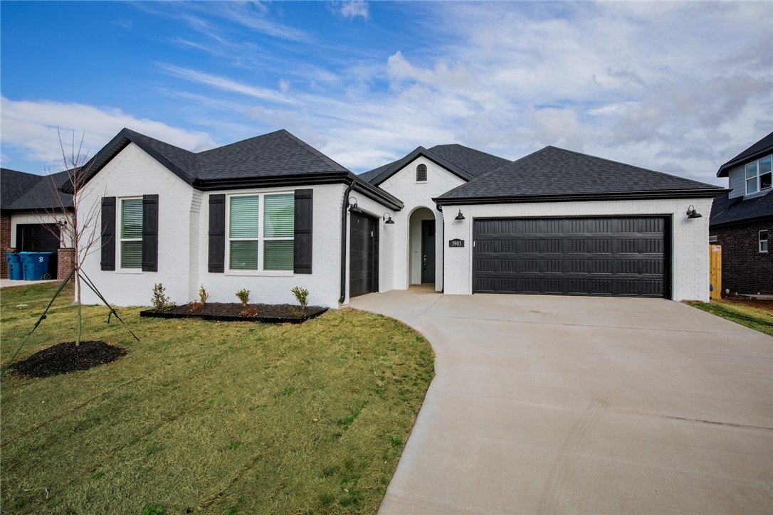 $3,000 if you use the preferred Lenders & fence, blinds and gutters included! MODEL HOMES located at 3801 & 3803 SW Pecan Cir. Snyder Meadows, a neighborhood nestled in West Bentonville. Grayson plan with the luxury package includes full tile shower, frameless shower door, Frigidaire Gallery line appliances, accent paint color in the dining, 3CM quartz, wainscoting in entry, LVP flooring in master & accent paint color on kitchen island. Stunning painted brick on the exterior! Home boasting an open floorplan, high ceilings, custom stained beams, cozy gas fireplace enveloped in shiplap & stained beam mantle. Chef's kitchen adorned with stainless steel appliances, gas range, pantry, quartz countertops, spacious kitchen island & captivating backsplash. Unwind in the luxurious master bedroom featuring LVP flooring and abundant natural light, while the spa-like master bathroom offers a walk-in tile shower with frameless glass door, double sinks, and walk-in closet. Set on a large lot with a covered patio.
