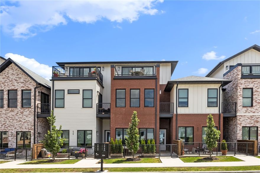 Embrace the vibrant Bentonville lifestyle at West Edge, townhome community where modern luxury meets unparalleled convenience. This exquisite 3-story unit, just one block from the highly anticipated STEM University (at the former Walmart Home Office site), offers a "modern classic" design aesthetic. Step inside to discover the elegance of white oak cabinets, premium white oak luxury vinyl flooring, and thoughtfully selected lighting. Large windows flood the space with natural light, complementing the impressive high ceilings. Outdoor living is a dream with a private, fenced front courtyard, a charming 2nd floor balcony, and a massive 3rd level party balcony – perfect for any occasion. The versatile top floor presents endless possibilities, whether you envision a spacious family room or a serene, spa-like primary retreat. Each bedroom has its own private full bath, ensuring ultimate comfort for all. This is more than a home; it's an invitation to live, love, and laugh in the dynamic heart of downtown Bentonville!