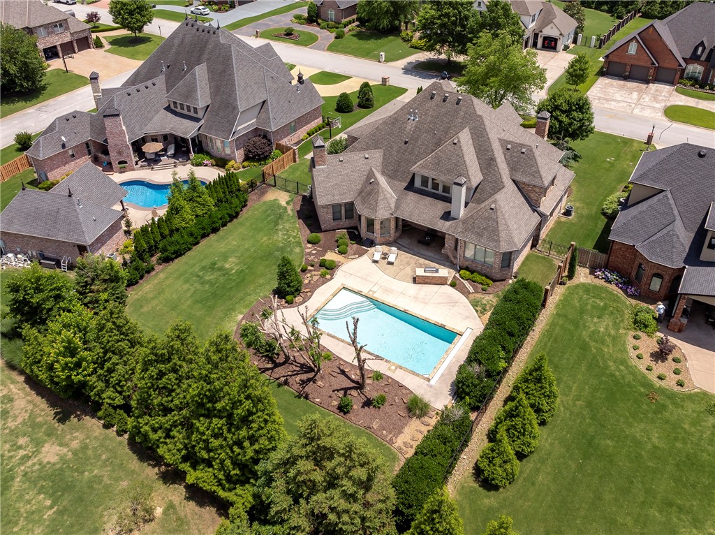 Experience grand scale luxury and inviting elegance in this 4 bed, 4.5 bath Pinnacle Country Club home in Bentonville schools! Enter through a stunning foyer with travertine floors and curved staircase into a vaulted, beamed family room and gourmet kitchen with hearth and breakfast area. Enjoy hand-scraped hardwoods, travertine, and upscale finishes throughout. The private study with fireplace and built-ins, wine room, game room with wet bar, and fully equipped theater offer endless entertainment. The primary suite features a spa-like bath. Outdoor living is a dream with covered patio, fireplace, grill, saltwater pool, and outdoor kitchenāall professionally landscaped. Major updates for peace of mind include: 3 new HVAC units, 2025 tankless water heater, new pool pump, and expanded matching hardwood floors. Style, comfort, and lifestyle all in one exquisite home!