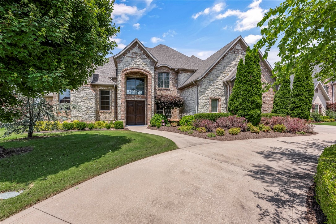 Experience grand scale luxury and inviting elegance in this 4 bed, 4.5 bath Pinnacle Country Club home in Bentonville schools! Enter through a stunning foyer with travertine floors and curved staircase into a vaulted, beamed family room and gourmet kitchen with hearth and breakfast area. Enjoy hand-scraped hardwoods, travertine, and upscale finishes throughout. The private study with fireplace and built-ins, wine room, game room with wet bar, and fully equipped theater offer endless entertainment. The primary suite features a spa-like bath. Outdoor living is a dream with covered patio, fireplace, grill, saltwater pool, and outdoor kitchen—all professionally landscaped. Major updates for peace of mind include: 3 new HVAC units, 2025 tankless water heater, new pool pump, and expanded matching hardwood floors. Style, comfort, and lifestyle all in one exquisite home!
