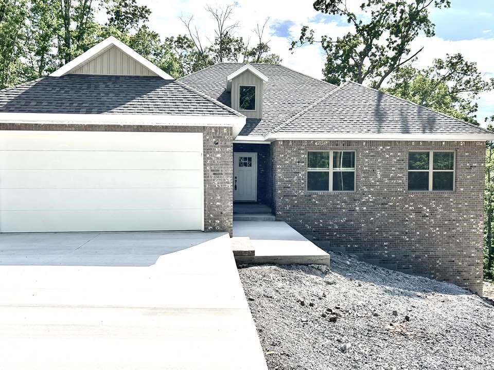 2025 New Construction on .53 acre lot surrounded by trees and nature. Minutes away from Loch Lomond, Lakepoint Restaurant and Marina, Branchwood Activity Center, Scotsdale Golf Course, and I49 for easy daily commute. Home features; split / open floor plan, wood laminate flooring throughout living areas, 3 bedrooms, 2 bathrooms, sunroom, eat-in kitchen w/ undermounted sink in island, granite countertops, microwave, & walk-in pantry. Foyer leads to living room w/ gas log fireplace including stone accents, wooden mantle, vaulted ceilings, & deck. Primary suite includes; double sink, deep soaking tub, walk-in shower, large walk-in closet. Primary closet connects to utility room. Large utility room includes built in coat rack. Relax on covered deck off back of home.