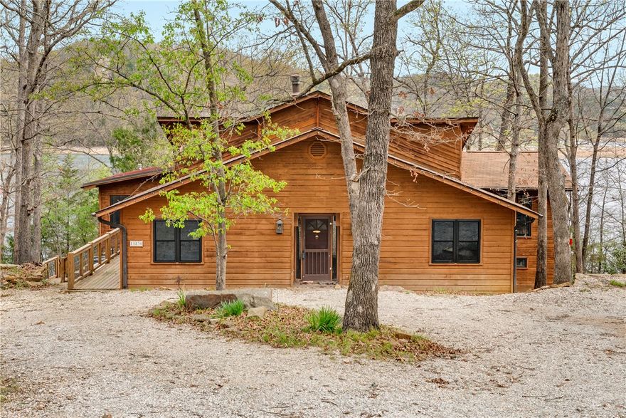 This beautifully designed lakeview residence offers a refined retreat where comfort and versatility come together. The main floor features a welcoming gathering area and a thoughtfully designed kitchen with a walk-in pantry, well suited for both daily routines and entertaining. Three bedrooms are positioned on this floor including a tranquil primary suite with a private sitting area and direct access to the deck—an ideal spot for morning coffee or unwinding while taking in the view. A screened porch and generous deck expand the home’s connection to the outdoors, offering a calming space for relaxation or social gatherings. On the lower level, a private bedroom and full bath are joined by a versatile bonus area leading to a workshop and lower deck, while an open upper story provides an airy setting ideal for a home office or creative escape. With a whole-house 18kW generator, the home offers effortless year-round living and a rare blend of seclusion and comfort.