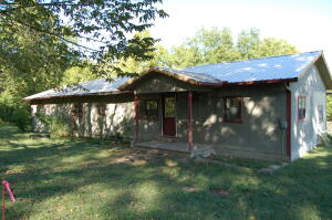 Beautiful country setting with year round creeks. This 5 bedroom, 2.5 bath home needs some TLC but if you're looking for country living, this might be perfect for you. Land features some pasture and some wooded, fenced and cross fenced and 2 barns/outbuildings. Red barn structure has very nice chicken coop built inside. Home had new metal roof installed approximately 3 years ago. New well pump & pressure tank just installed! Less than 10 miles to Bull Shoals Lake public use area & Diamond Hills Country Club & approximately 40 minute drive to Branson. All numbers & info per county records. Buyer should perform own due diligence. Property being sold AS IS!