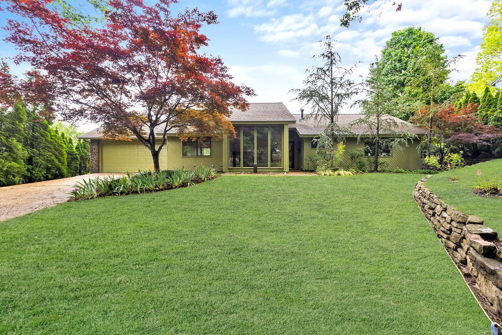Remarkable home in the Lake Road Estates! Tucked in serene and established neighborhood, this custom-built contemporary home blends modern style w/ natural beauty. Step inside to vaulted ceilings and floor-to-ceiling windows that fill the open living space w/ natural light. Kitchen features new granite countertops & backsplash, s.s. appliances and abundant cabinetry. Formal dining room offers a warm, inviting space for entertaining. Three spacious bedrooms, each w/ walk-in closets, and two beautifully renovated bathrooms. Tastefully updated w/ freshly painted interior, exterior including deck, new LVP flooring, newer AC unit, and updated fireplace tile add fresh style throughout. Expansive yard is a peaceful retreat, professionally landscaped w/ rock walls, native Arkansas plants, rock and surrounded by mature trees for privacy. Walking distance to Lake Fayettevilleās park and trails, and moments from schools, shopping, dining, and Springdale Country Club. Donāt miss your chance to call this stunning property home!
