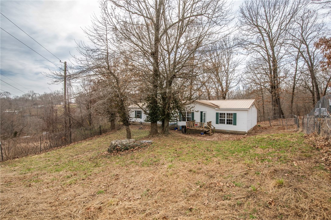 Seller offering up to $3,000 toward buyer's closing costs with acceptable offer! This 3 bed 2 bath manufactured home on a permanent foundation sits on 0.98 acres. Additionally you will enjoy having plenty of entertaining space with a second living area. Features of this home include metal roof, gas log fireplace, large bedrooms, walk-in closets and a whirlpool tub in the master. This property is conveniently located just minutes to Pea Ridge & Rogers!