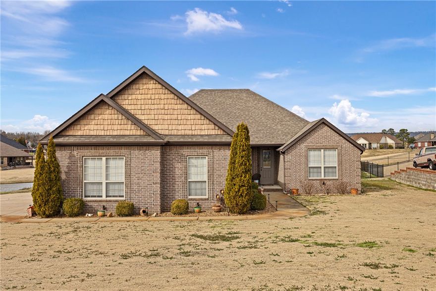 ELEGANT AND INVITING!!!  Beautiful  4-bedroom, 2 bath home featuring a cozy fireplace and spacious 3 car garage.  Enjoy stunning golf course-style landscaping and a large deck for entertaining or relaxing.  The fenced backyard overlooks a peaceful pond, offering serene views you'll love coming home to.