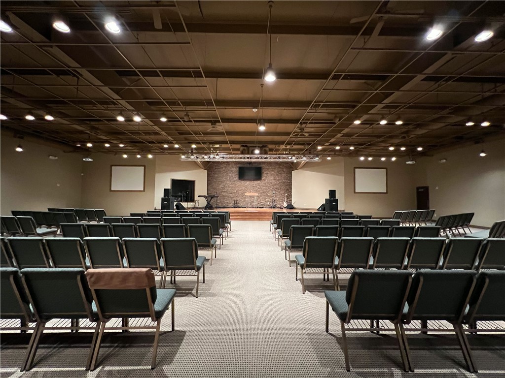 Must see property! This 19,224 sq ft upgraded building on 1.93 acres has unlimited potential! This is a rare finding in this area! Currently used as a church with over 1200 sq ft of office space on the first floor, a bookstore, area for nursery, children's ministry, youth department, classroom/conference room, various storage areas and a laundry area. It features a central gathering area, with full kitchen and very inviting and relaxing cafe-like area of over 3500 sq ft which is a great place to entertain, mingle or provide a great meal with the full kitchen available. The main sanctuary boasts over 4600 sq ft comfortably seating over 300 guests. The platform has hardwood flooring, and a beautiful stack rock wall. Property is just 5 mins to-I49 for easy access. Once a skating rink this could be transformed into almost any type of business, day care, gym, or manufacturing facility. With properties of this quality becoming scarcer in the area this one won't last long!! Come and see this before it's gone!!