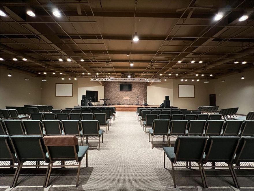 Must see property! This 19,224 sq ft upgraded building on 1.93 acres has unlimited potential! This is a rare finding in this area! Currently used as a church with over 1200 sq ft of office space on the first floor, a bookstore, area for nursery, children's ministry, youth department, classroom/conference room, various storage areas and a laundry area.  It features a central gathering area, with full kitchen and very inviting and relaxing cafe-like area of over 3500 sq ft which is a great place to entertain, mingle or provide a great meal with the full kitchen available.  The main sanctuary boasts over 4600 sq ft comfortably seating over 300 guests. The platform has hardwood flooring, and a beautiful stack rock wall. Property is just 5 mins to-I49 for easy access. Once a skating rink this could be transformed into almost any type of business, day care, gym, or manufacturing facility. With properties of this quality becoming scarcer in the area this one won't last long!! Come and see this before it's gone!!