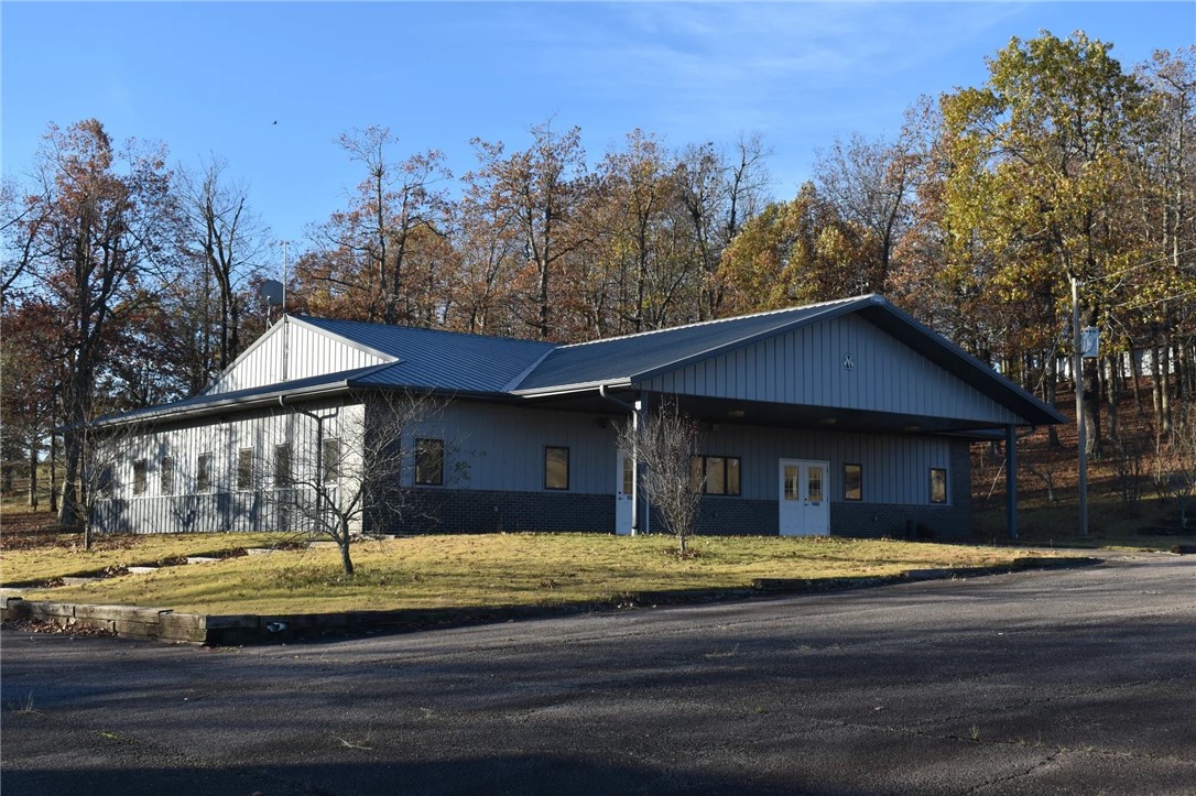 Situated on 8.8 acres in the scenic Ozark Mountains, this property combines functionality and versatility, making it an excellent fit for a range of uses. The site features a 3,672 SF office building that could be converted into living quarters, a 3,750 SF 4-bay facility, a 2,470 SF 3-bay facility with a loading dock, a 3,970 SF metal barn and two mobile homes (1,155 SF & 440 SF) providing ample space for storage or light industrial operations.
Located less than 1.5 ± miles from the Ozark National Forest, this property also offers unique appeal to outdoor enthusiasts seeking a rural retreat. The panoramic mountain views and peaceful surroundings create additional potential for converting this site into a secluded homesite on acreage with ample storage.