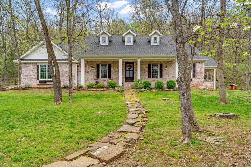 Beautifully maintained 4-bedroom home nestled on 6.01 acres of gently rolling land, offering a perfect
balance of privacy, charm, and comfort. Vaulted ceilings enhance the bright, open feel throughout the
living areas, while brick flooring adds warmth and character. The kitchen features a spacious layout with a
large island ideal for casual meals or entertaining, ample pantry storage, and a built-in wine nook that
combines style and function. The primary suite is a true retreat with dual sinks, a tiled walk-in shower,
and an oversized walk-in closet. Each additional bedroom provides flexible space for guests, an office, or
hobbies. Step outside to a scenic backyard with mature trees, a fire pit area, and the gentle sound of a
creek creating a peaceful, nature-filled setting. Ideal for those seeking tranquility without sacrificing
convenience. Room to roam, garden, or relax under the stars. This home blends indoor comfort with
outdoor serenity for a truly special lifestyle.