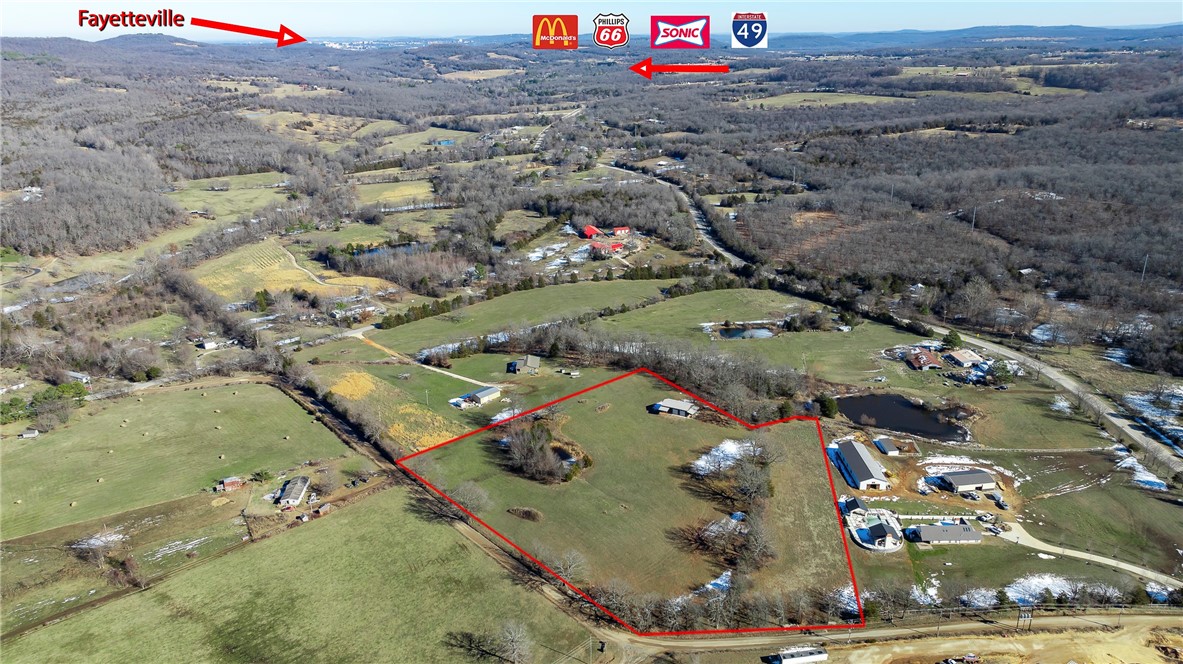 Motivated Seller says Make Offer! 7.58+/-acres w/hilltop building views is gently rolling, has a small pond, partially wooded & is rural but close to I-49 & many other places: 6mins to I-49 access, 8mins to Greenland, 10mins to Prairie Grove, 15mins to Razorback Stadium in Fayetteville. Two separate locked entry gates offer options on how you want to access your property. ($80K value) 2019 well-built 50x30 Shop/Barn Bldg w/Lean-To Shed for covered storage, thick concrete floor, three 10' garage doors & plumb access if you choose to install a bath. This could be your barn-dominium ready to complete OR this is your Workshop & build your forever home here OR stay in your RV or MF housing while you build your main home onsite. Electric & Public Water available to connect nearby, Propane needed for gas, Private Septic needed & a perc test allowed for 2-build sites for 3bdrm sized home. Plat available for Tract #3. Some farm equipment & supplies present in Shop have already been sold, but some are still negotiable.