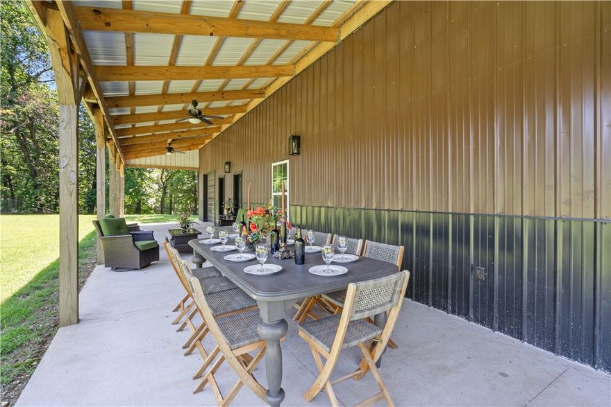 Nestled on 18 scenic acres, this 2,175 sq ft barndominium blends comfort and functionality just seconds from the city, yet miles from the mayhem. The home features 2.5 baths, a main-floor master suite with walk-in closet, laundry, and extra storage. Upstairs offers two bedrooms, a full bath, and two bonus rooms. The kitchen boasts dual pantries, while custom shutters add charm throughout. A climate-controlled dog room with grooming area and hot/cold water makes pet care a breeze. Enjoy outdoor living with front and back covered patios, a built-in fire pit, and a peaceful water feature. The oversized garage fits an RV or ample storage, plus there's a pole shed and extra garage/workshop. Fenced pasture includes a water source—ideal for your homestead and or horses. This is a rare gem that provides privacy as well as potential. Installed lighting highlights selected trees and the water fetaure enhancing your serenity.