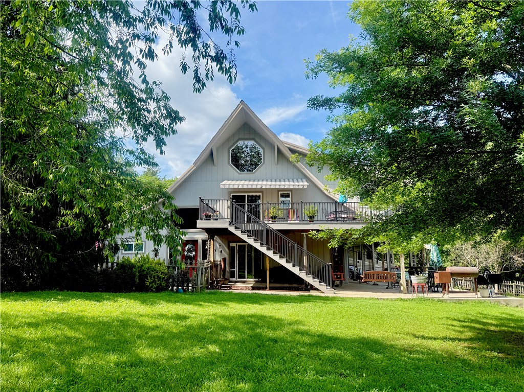 Professional photos coming soon. Rustic charm meets modern comfort in this beautifully converted barn home on nearly 6 acres, just minutes from Rocky Branch Marina. Featuring pine cathedral ceilings, a newly updated kitchen, and an outdoor elevator from the patio to the second floor, this unique property offers character and convenience. Enjoy stunning pastoral views, a wet-weather creek, and direct walkable access to Beaver Lake—perfect for kayaking adventures. Outdoor living shines with multiple decks, a hot tub, movie screen setup, RV covered parking, a pond, large garden, and additional barn. A one-of-a-kind retreat with space to relax, explore, and entertain.