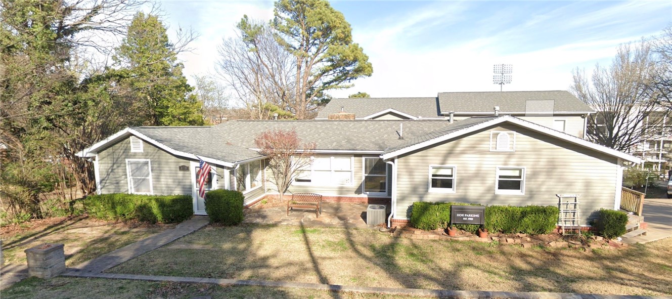 Directly across from Razorback Stadium, this iconic game-day property is a fan’s dream! Remodeled and expanded in 2013, this sprawling 7-bedroom, 6-bath residence boasts TWO kitchens, a massive 42'×25' media/game room, and 3 private ensuites. Wander the beautifully landscaped grounds wired for electric & cable to find a two-story treehouse with TV mounts, WiFi & power. Ideal for entertaining or multigenerational living. Driveway shared with 400 N Oliver.