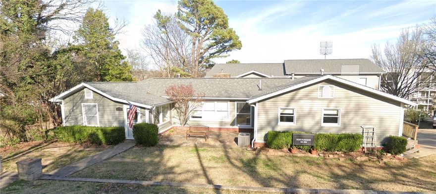 Directly across from Razorback Stadium, this iconic game-day property is a fan’s dream! Remodeled and expanded in 2013, this sprawling 7-bedroom, 6-bath residence boasts TWO kitchens, a massive 42'×25' media/game room, and 3 private ensuites. Wander the beautifully landscaped grounds wired for electric & cable to find a two-story treehouse with TV mounts, WiFi & power. Ideal for entertaining or multigenerational living. Driveway shared with 400 N Oliver.
