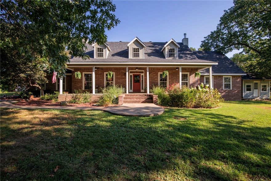 Welcome to your dream retreat—nestled behind trees on 10 private acres. This stunning property offers space & family-friendly amenities, outside city limits but minutes from town.  Outside, you will enjoy access to a fully stocked 7-acre lake, shared with only 3 neighboring properties-ideal for fishing or relaxing. The backyard features a semi-inground pool & splash pad, hot tub, outdoor movie screen, & a massive custom playground complete with forts, tunnels, slides, & swings. A 40’ x 44’ barn with lean-to offers ideal storage or workspace. Inside this rustic home is a large kitchen, dining, & hearth room with a wood burning stove featuring beautiful hardwood floors & a tongue & groove ceiling. With 4 large bedrooms, a bonus room (could be a 5th), & a dedicated office, this home has lots of space. Designed with storage in mind, it offers plenty of closet space, a large laundry/mud room, & a roomy closet in the living room that leads to a storm cellar.
