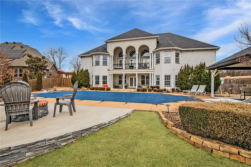 Nestled in the perfect location near the Pinnacle area, AMP concert venue, Top Golf, and bustling shopping centers, this home offers unparalleled convenience. Step out your front door onto the Razorback Greenway Trail for scenic walks or bike rides. Enjoy the luxury of a heated private in-ground pool with a gazebo, patio area, and firepit, all set on over half an acre lot. Inside, discover a ton of updates throughout, including a fully renovated kitchen boasting large kitchen island, quartz countertops, stainless steel appliances, pantry and eat in area. The living room features soaring ceilings, abundant natural light, stacked stone fireplace, built-ins and double doors opening to the balcony overlooking the yard. Entertain effortlessly in the walk-out bonus area or get work done in the study. Large primary bedroom offers a door to the balcony, sitting area, and a spa-like bathroom complete with heated floors, double sinks, walk-in tile shower, jetted tub, and a spacious walk-in closet.