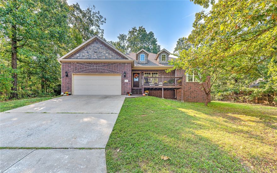 Tucked into the trees on a quiet Bella Vista street, this updated, level-entry brick home blends low-maintenance living with high-end comfort. Enjoy peace of mind with new appliances, new carpet in the back room and closets, and a fresh coat of paint that brightens every space. A cozy gas-log fireplace anchors the living room, while the refreshed deck is perfect for morning coffee or evening unwinding. The fully fenced, FLAT backyard offers privacy for pets, play, or gardening. The primary suite features not just one, but two walk-in closets and a deep soaking tub—your own private retreat after a long day. Located just 2 miles from Back 40 Trails, Gear Garden, and Metfield Golf & Skills Park, adventure and relaxation are always nearby. With a smart layout, move-in-ready updates, and unbeatable access to lakes, parks, and trails, this home is a rare find in one of Bella Vista’s most sought-after pockets.