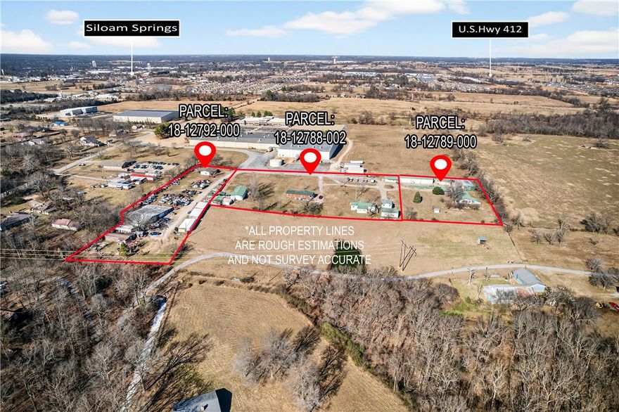 Income-Producing Mixed-Use Property | 7.85± Acres | No Deed Restrictions. Investment opportunity on 7.85± unrestricted acres in Siloam Springs. Located outside city limits this property offers rare flexibility for continued mixed-use operations or future redevelopment. Improvements include a 4,960± sq ft service/repair garage, transmission shop, storage facilities, automotive-related structures, a barnominium, a two-bedroom apartment, single-family residence, mobile homes, storage trailers, and more. Existing uses include automotive service operations, residential rentals, and salvage/junk yard activity. The property currently generates rental income below market, with most units occupied. With multiple parcels and ample acreage, potential uses include continued mixed-use investment, contractor or equipment yard, automotive or industrial services, additional residential units, tiny home or mobile home community, RV park, or future multi-family development (buyer to verify feasibility). Offered as-is.
