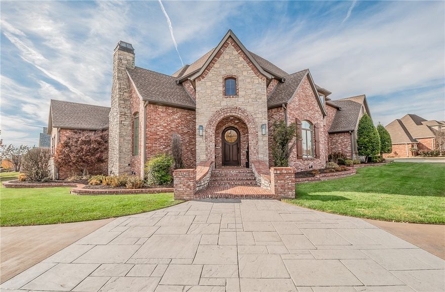 Located on a spacious corner lot in the refined haven of Pinnacle Country Club, this French inspired estate captivates w/its signature symmetrical design, steeply pitched roofs and stone & brick facade. The elegant 4,703 sf interior is designed for comfort & style and adorned with newly refinished hardwood flooring, updated designer paint palette, plantation shutters and boasts high ceilings w/ornate moldings & expansive windows. Formal living areas embellished w/cast stone fireplaces & designer fixtures seamlessly connect w/a cozy reading loft & home theater, creating a harmonious balance between grand entertaining & intimate relaxation. The heart of the home is the gourmet kitchen, equipped w/high end appliances integrated into custom cabinetry & bay window dinette that opens to a spacious covered veranda for alfresco dining.  The manicured property includes lush landscape beds, separate gated lawn space, covered veranda, balcony terrace & a gorgeous heated pool, providing a serene backdrop for outdoor leisure.