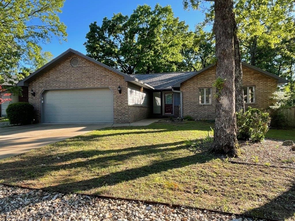 Discover this beautifully kept gem on a nearly level lot offering comfort, style, and a prime location for an active lifestyle. Enjoy recent new flooring, fresh interior paint throughout, and newly painted cabinets and fireplace, giving this home a modern and inviting feel. 750-gallon septic tank. Versatile All-Season Room: Perfect for relaxing year-round, this bonus space can be used as a sunroom, home office, or playroom. Situated close to popular biking trails and just minutes from three of Bella Vista's stunning lakes, making it ideal for outdoor activities like biking, fishing, and boating. Conveniently located near clubhouses, golf courses, and local restaurants, this home is perfect for those looking to enjoy the best of Bella Vista living. The previous contract fell through at no fault of the seller, offering you a second chance at this incredible home!