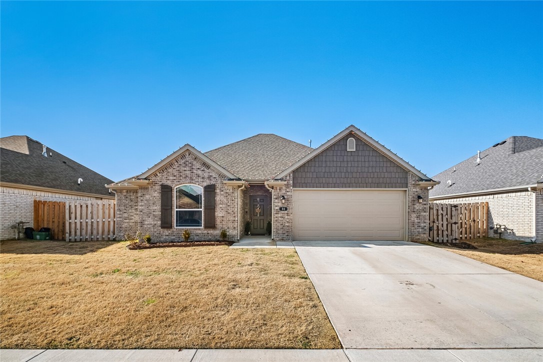 Experience the perfect blend of modern upgrades and convenience in a peaceful setting. Just minutes from shopping, restaurants, and easy access to I-49, this beautifully designed 3-bedroom, 2-bath all-brick home features an open floor plan and an abundance of natural light. The spacious living room is ideal for both family gatherings and entertaining, while the kitchen, complete with a large island and sleek modern appliances, combines style with functionality. Thoughtful upgrades include an undermount farmhouse sink, pocket doors, raised toilets, extended back patio, under-cabinet lighting, and durable luxury vinyl plank flooring throughout. High ceilings, blinds, and gutters further elevate the comfort and appeal of this home. This home is a perfect balance of elegance and everyday living, making it a great choice for your next home