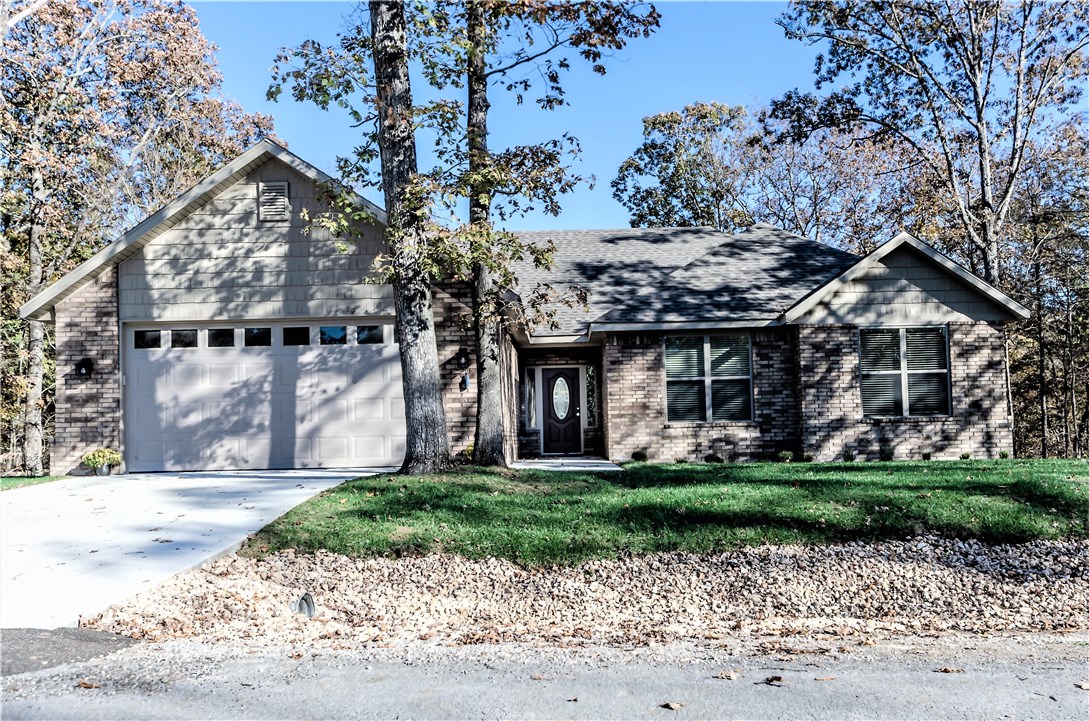 Custom Built move in now!! 3 bedroom 2 full baths. Double vanities and sinks. Gourmet kitchen with designer countertops. Great open floor plan with ceramic wood tile floors, opening to a large covered deck 12 ft x 20 ft. Flat driveway. Vaulted ceiling in living room and gas log fire place. Master suite with large master bath soaking tub and shower. Walk in closet extra storage . Lots of custom features. Carpet in bedrooms and woodgrain tile in rest of house. Fully professionally landscaped. Flat yard. Close to Hwy 71.