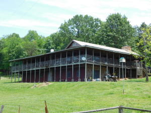 Nice Home, 9.07 ac m/l, and RV park setup for the horse riders or hikers. Located just across the road from the Center Point Trail Head of the Buffalo National River. This income producing property includes a 3600SF 3BR 2BATH home with rock fireplace and insert, tile with wood floor stamp and hardwood floors, unfinished basement, with RV hookups & horse corrals, guest cabin, campground shower house, spring-fed pond, fenced, highway frontage, outstanding sunset view. House could easily be a 4 or 5 bedroom house because there are 3 others rooms being used for game room, office, and exercise room.The RV park and Horse Camp includes (6) campsites with 20 and 30 AMP electric (accommodates 50 AMP hookups) & water and (1) dump station; (12) 12 x 12 horse pens and (1) 20' round pen.