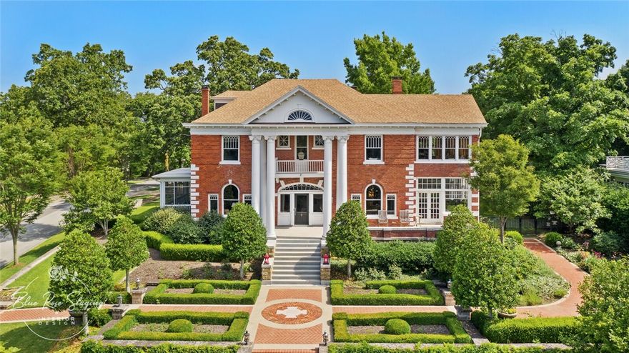 This iconic home is grandly positioned in the city’s National Historic Landmark District, with hilltop views of the Boston Mountains. Completed in 1906, this property is one of the state’s most elegant and well-preserved classical Georgian estates. The home has been meticulously restored in keeping with the period of the home along with luxurious 21st-century updates. The 5,108 interior is arranged over two floors, with 4 bedrooms, 3 full baths, spacious entertaining rooms, a gorgeous conservatory and fully updated kitchen with cherry cabinetry and zinc countertops that have a natural patina. Of particular note is the foyer featuring a grand solid wood staircase with a custom painted art glass window dated 1916. The landscaped grounds are equally remarkable with formal, tailored gardens bordered by manicured lawns.