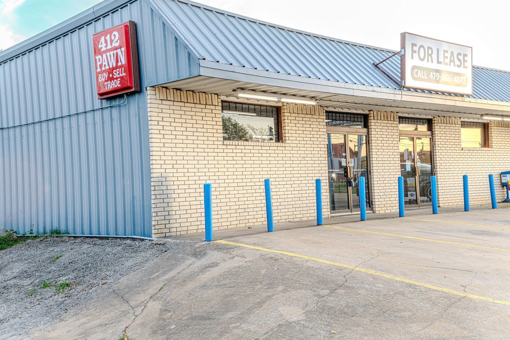 Commercial property featuring a brick facade and a