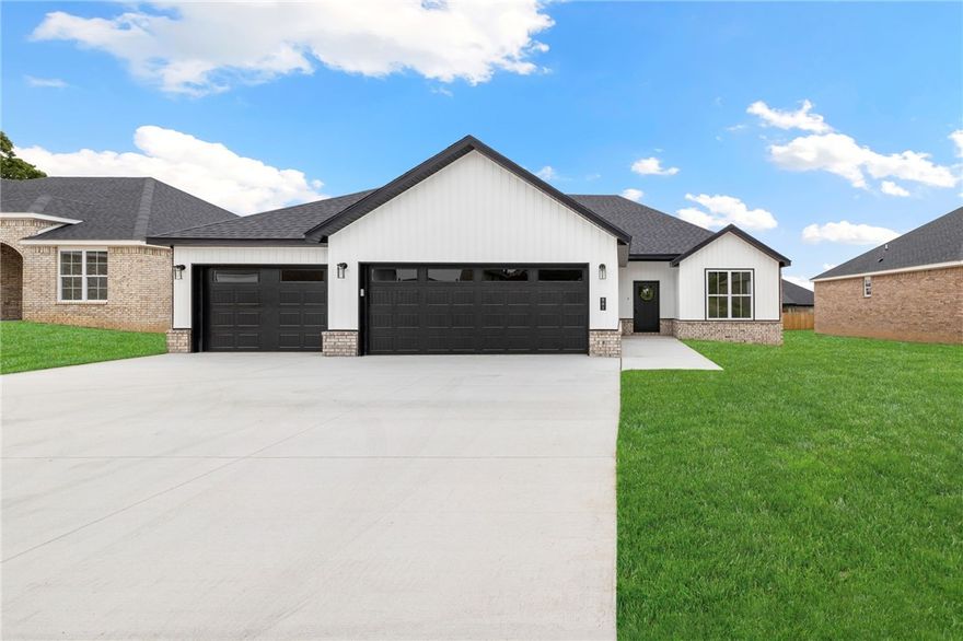 Contemporary living meets small town charm! This quality-built new construction home features a maintenance-free exterior and an incredible open concept/split floorplan with on-trend upgrades:  luxury vinyl plank flooring, a drop zone with built-ins from the 3-car garage, ceiling-height cabinets, granite countertops, under-cabinet lighting, pocket office with double doors for privacy, pantry, gas fireplace, covered deck with fan, and more. You’ll love the easy flow of the laundry room connecting to the owner’s suite! Situated conveniently off the bypass in one of Prairie Grove’s most desirable areas, Mountain View Estates gives you a quick commute to i-49 while cozying into a quaint downtown scene best known for antiquing and its rich history. Become a part of this vibrant, tight-knit community plus enjoy fast access to all your favorite Fayetteville amenities... truly, this wonderful home offers the best of both worlds!