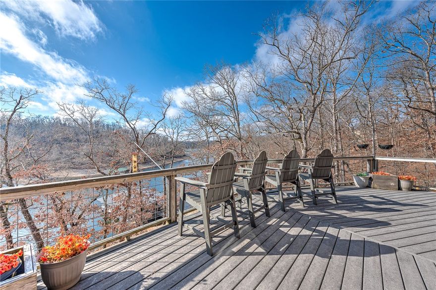 This architectural lakefront home has everything you've been looking for - an easy walk to the water, panoramic views, a boat slip - and more! This 1.5 acre property offers 200 ft of shoreline, a 3,508 sqft main house w/ 3-beds & 3.5-baths and a detached garage w/ 1-bed/1-bath mother in-law's suite. Both have been updated with modern touches like quartz and granite counters tops and all bedrooms have lake-views and deck access. Just a short gentle walk to your 10x24 covered boat slip in the community dock. Entertainment spaces abound indoors and out with an expansive two-level deck, large fire pit, and hot tub (which conveys!). Inside, relax in the spacious upstairs living room by the fireplace or downstairs in the basement game room. Current owners operate the main house as a highly-rated short-term rental. Offset the cost of ownership by continuing or rent the ADU long-term. Located in a quiet cove off Coose Hollow, this property is a short boat ride from Prairie Creek Marina and 25 minutes from Downtown Rogers.