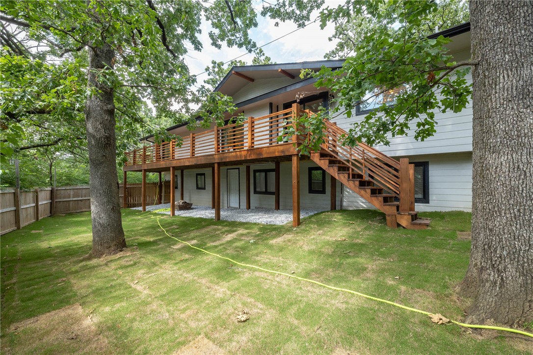 Completely remodeled in 2020 and just 1 mile from the University of Arkansas, Razorback Stadium, and Dickson Street, this spacious 4-bedroom, 3.5-bath home offers over 3,400 sqft of modern living in a prime Fayetteville location. Every major system has been upgraded, including a new roof, siding, windows, two HVAC units, hot water heater, plumbing, electrical, and added insulation. Inside, you’ll find fresh paint, new carpet and vinyl flooring downstairs, and a bright, open layout with cathedral ceilings. The kitchen features a large island with bar seating, granite countertops, stainless appliances, and a built-in wine fridge. The primary suite includes a walk-in closet, jetted tub, and a huge walk-in shower. Outside, enjoy fresh landscaping, new sod, a freshly stained front patio, and a newly stained deck that runs the full width of the home. A nearby trail at the end of the street connects directly to campus, adding even more convenience to this beautifully updated home.