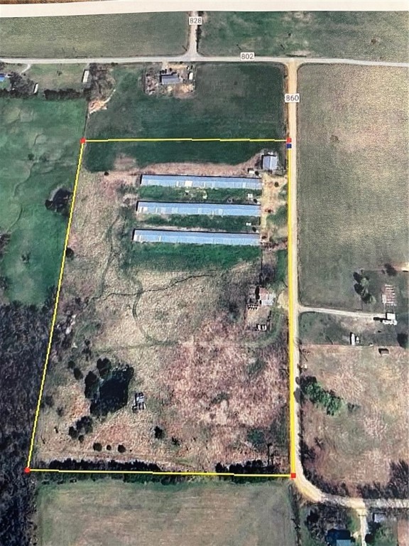 16.4 acres of level ground with County Road frontage. Property includes 3 poultry houses that have all the equipment in them. Also a Stacking shed. Litter has been cleaned out of the houses. Poultry houses are fully equipped and ready to raised birds. There is no contract to raise birds at this farm presently. This property has G F city water on it and electric. Many possibilities here. Steel pipe corral and head chute located at the corner of the property.