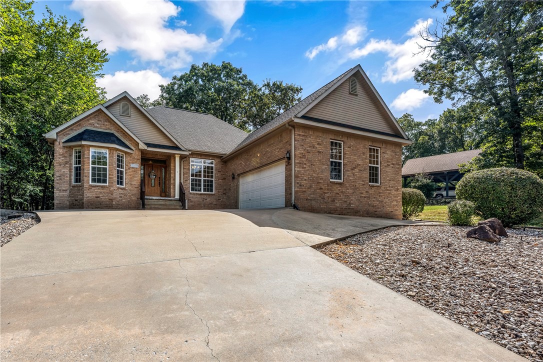 Walking distance to the Metfield Clubhouse and golf course, and just a short drive to Downtown Bentonville! The spacious living room features engineered hardwood floors, a tray ceiling, crown molding, a cozy gas fireplace, and an open floorplan filled with natural light. The large kitchen offers abundant storage, expansive counter space, and an eat-in area that flows seamlessly into the living room. A stunning formal dining room highlights crown molding, bright windows, and easy access to the kitchen, perfect for entertaining. The generous primary suite includes a spa-like bath with double sinks, a jetted tub, walk-in shower, and oversized walk-in closet. A convenient utility room provides plenty of storage, and the oversized garage offers additional space. Outdoors, relax on the covered deck or gather on the extended patio with pergola, all overlooking the beautiful, tree-filled surroundings.