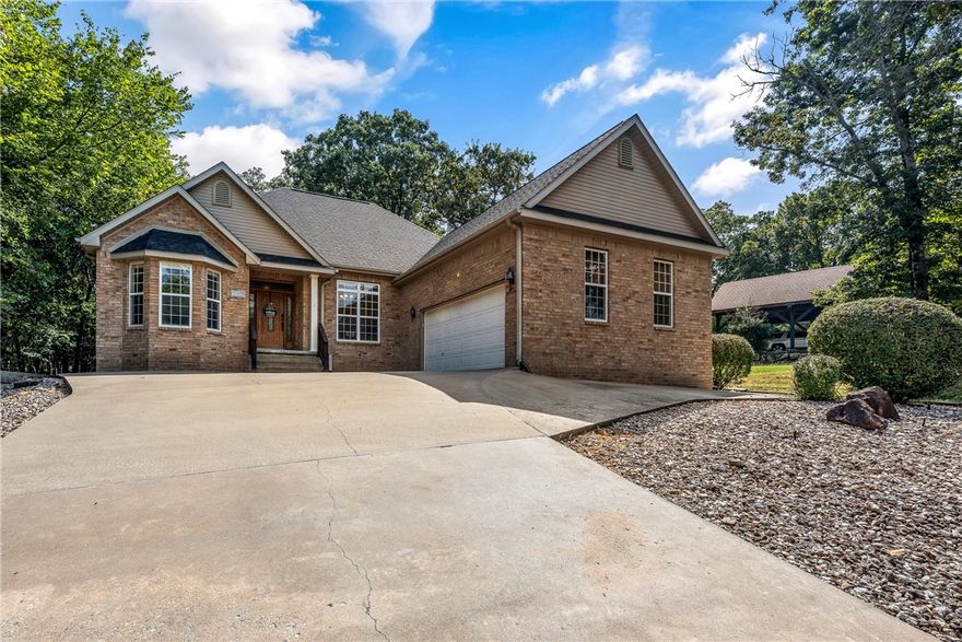Walking distance to the Metfield Clubhouse and golf course, and just a short drive to Downtown Bentonville! The spacious living room features engineered hardwood floors, a tray ceiling, crown molding, a cozy gas fireplace, and an open floorplan filled with natural light. The large kitchen offers abundant storage, expansive counter space, and an eat-in area that flows seamlessly into the living room. A stunning formal dining room highlights crown molding, bright windows, and easy access to the kitchen, perfect for entertaining. The generous primary suite includes a spa-like bath with double sinks, a jetted tub, walk-in shower, and oversized walk-in closet. A convenient utility room provides plenty of storage, and the oversized garage offers additional space. Outdoors, relax on the covered deck or gather on the extended patio with pergola, all overlooking the beautiful, tree-filled surroundings.